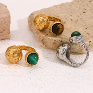 Detail of vintage 18K gold plated lava texture open ring with green agate stone
