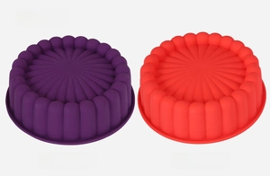 Detailed view of fluted silicone cake molds in vibrant purple and red for baking
