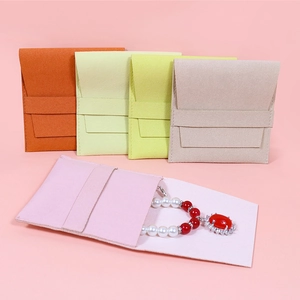 Microfiber envelope jewelry pouches in pastel colors with tie ribbon closure