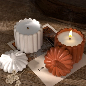 Macro detail of pumpkin shaped scented candles with matching relief lids and matte texture