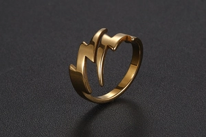 Macro shot of golden lightning bolt stainless steel ring with a sleek streamlined design