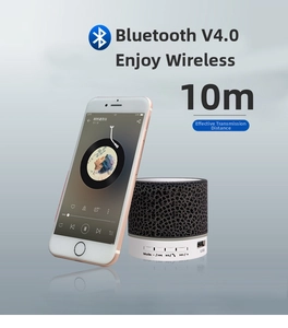Detail view of portable crackle-pattern bluetooth speaker with USB port and controls