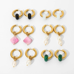 Set of six gold hoop earrings with pearls and colorful natural stone charms on white background