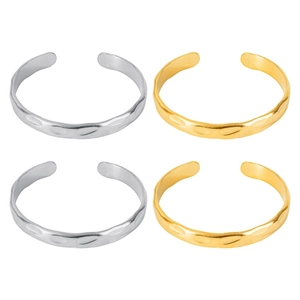 Detailed view of adjustable hammer textured bangles in gold and silver finishes