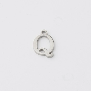 Macro detail of polished stainless steel letter Q pendant with mirror finish and hanging ring
