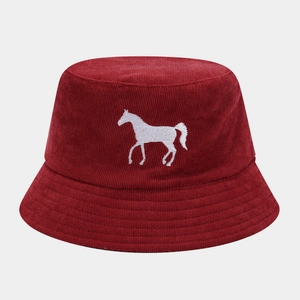 Detailed view of the dark red corduroy fabric and white horse embroidery on the bucket hat
