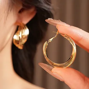 Luxurious layered gold hoop earrings with minimalist twisted design for a modern aesthetic