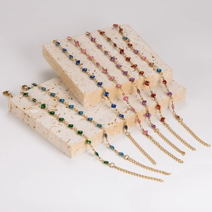 Golden stainless steel chain bracelet featuring colorful square cut gemstone inserts