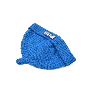 Close-up of royal blue chunky knit baby hat featuring a white bild logo patch on the cuff