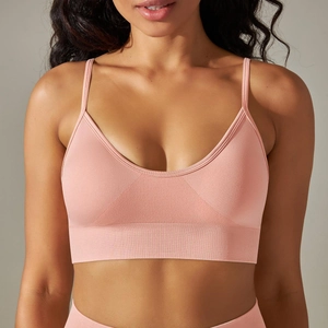 Detailed view of seamless ribbed pink sports bra with thin straps and U-neckline