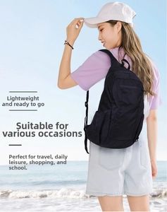 Waterproof lightweight black backpack used for outdoor travel on a sunny beach setting