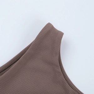 Macro detail of brown ribbed knit fabric texture and high-quality stitching on the shoulder