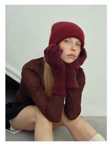 Close-up of wine red wool blend knit hat and gloves set with soft fuzzy texture