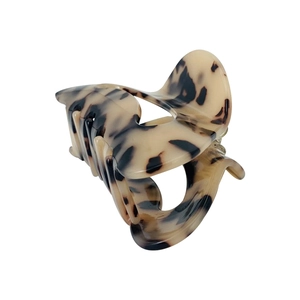 Detail of tortoiseshell acetate crescent hair claw clip with a polished finish