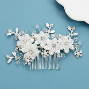 Close-up of handmade bridal hair comb with white 3D flowers and crystal beads
