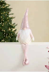 Pink Christmas gnome plush toy with metallic hat and long beard on white background