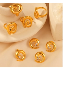 Detailed view of golden twisted spiral jewelry set with shimmering cubic zirconia stones