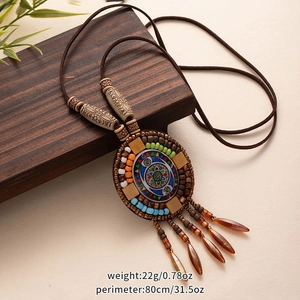Detail of bohemian pendant with wooden beads, colorful fringe and product dimensions