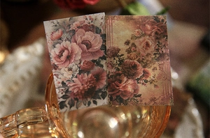 Close-up of vintage rose floral scrapbook stickers on an amber glass cup