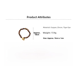 Macro detail of Tiger Eye stone beads with gold plated gourd pendant and zircon inlay