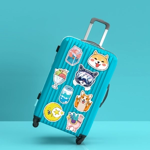 Close-up of VSCO stickers featuring cute animals on a blue ribbed hard suitcase