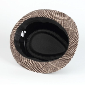 Internal detail of plaid jazz hat showing sweatband and material composition tag