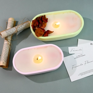 Detailed top view of pastel scented candles with dry rose petals in oval silicone molds