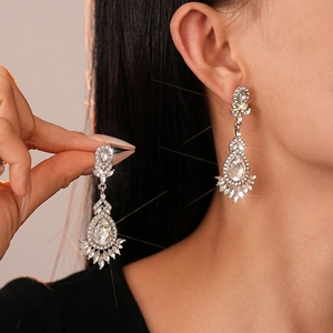 Sparkling silver drop earrings with floral rhinestones worn on model for a luxury look