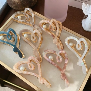 Elegant heart-shaped acetate hair claws with pearls and metal springs in various colors