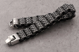 Close-up of black woven leather bracelet with polished silver stainless steel buckle