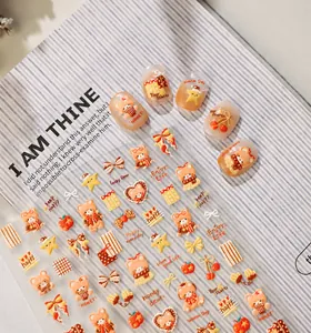 Detail of honey caramel bear nail stickers with bows and stars on blue background