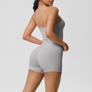 Detailed back view of light gray yoga romper with thin cross straps and open back design