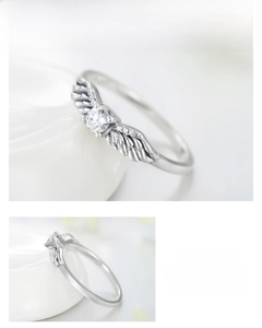 Macro detail of S925 sterling silver angel wing ring with sparkling zircon inlays