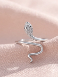 Detailed view of silver snake ring featuring micro-paved zircons and black gemstone eyes