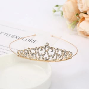 Detailed close-up of golden bridal tiara with sparkling rhinestones and heart patterns