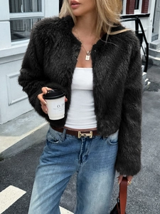 Detail of soft dark brown faux fur texture on a round neck long sleeve winter coat