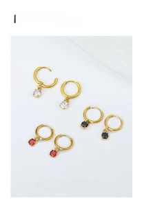 Detail view of gold hoop earrings set with sparkling zircon in red black and white