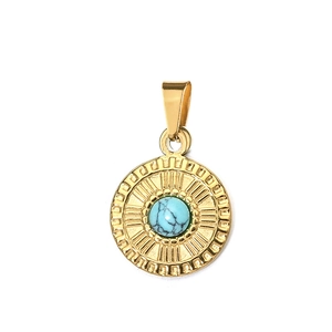 Detailed close-up of golden sunburst pendant with center turquoise stone inlay