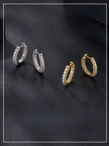 Close-up of sparkling moissanite hoop earrings in silver and gold finishes