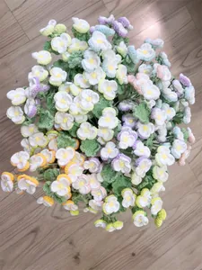 Detail of colorful hand-knitted crochet pansy bouquet on a rustic wooden background