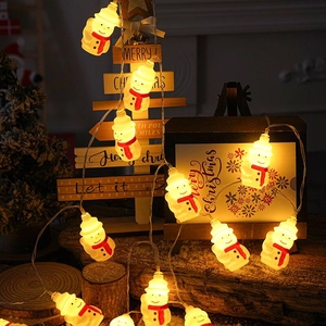 LED snowman fairy lights with warm yellow glow wrapped on a rustic wooden Christmas tree
