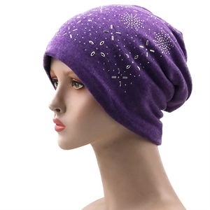 Purple knit beanie with sparkling rhinestone star patterns on a model mannequin head