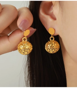 Close-up of 18K gold plated hollow bead earrings featuring micro-set cubic zirconia