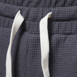 Men's dark grey waffle texture athletic shorts with white drawstring waist details