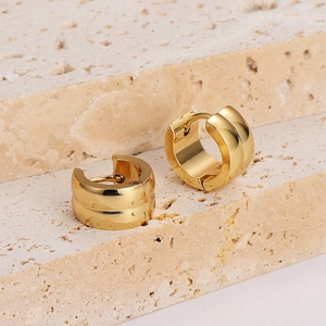 Golden stainless steel wide hoop earrings with center groove on textured stone base