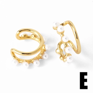 Detailed close-up of double-layered gold ear cuff with white pearls and zirconia accents
