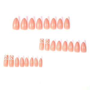 French tip press-on nails set with heart design in nude pink and white medium almond