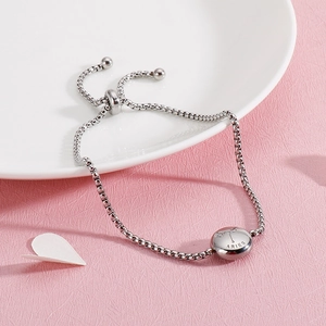 Detailed shot of silver Aries zodiac charm bracelet with adjustable sliding buckle