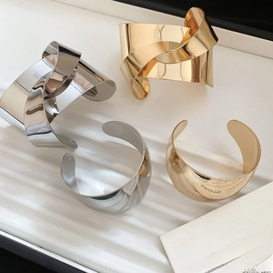 Polished metallic knot and minimalist open cuff bracelets in gold and silver finishes