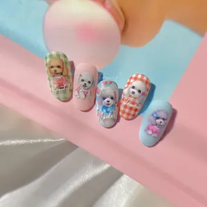 Macro detail of 5D embossed nail stickers featuring cute hand-painted dog designs and patterns